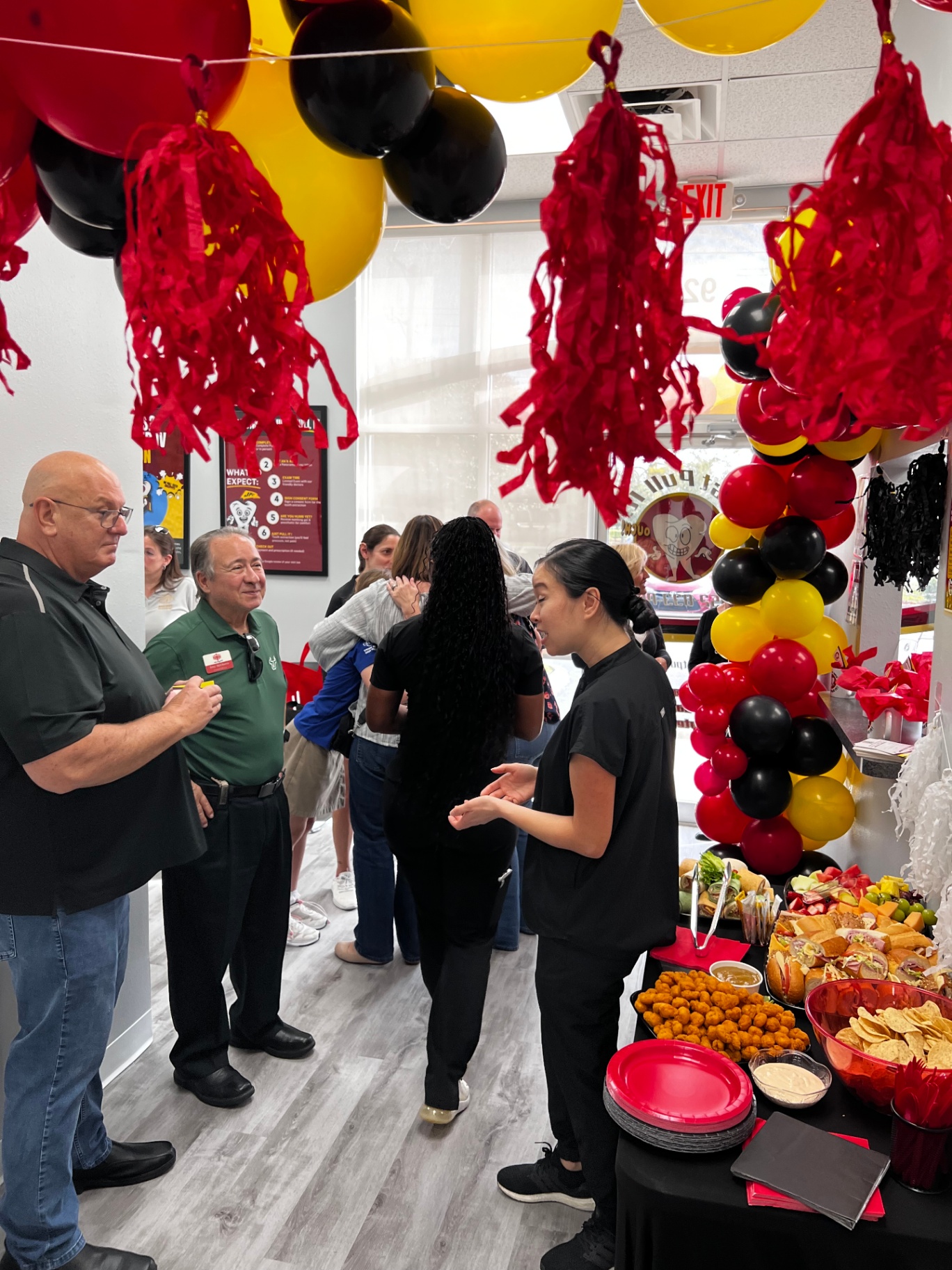 Guests mingling inside the Brandon office during the grand opening