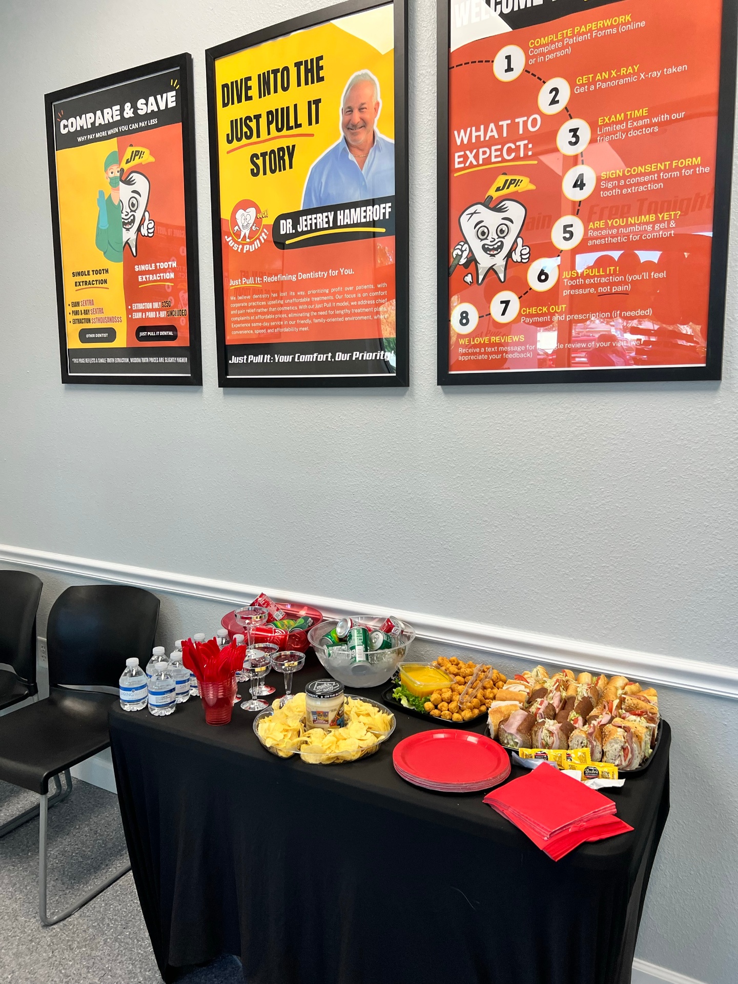 Refreshment table under the Compare & Save and Dr. Hameroff posters at the Lutz office