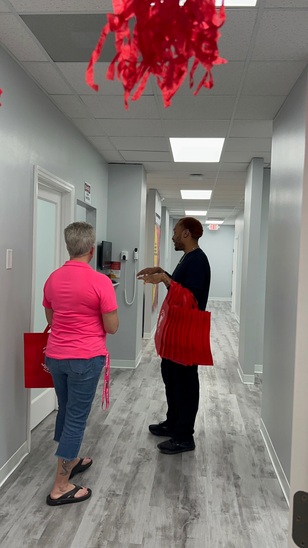 Team member giving a tour down the Brandon office hallway
