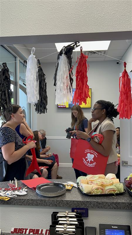Guests mingling inside the Lutz office during the grand opening