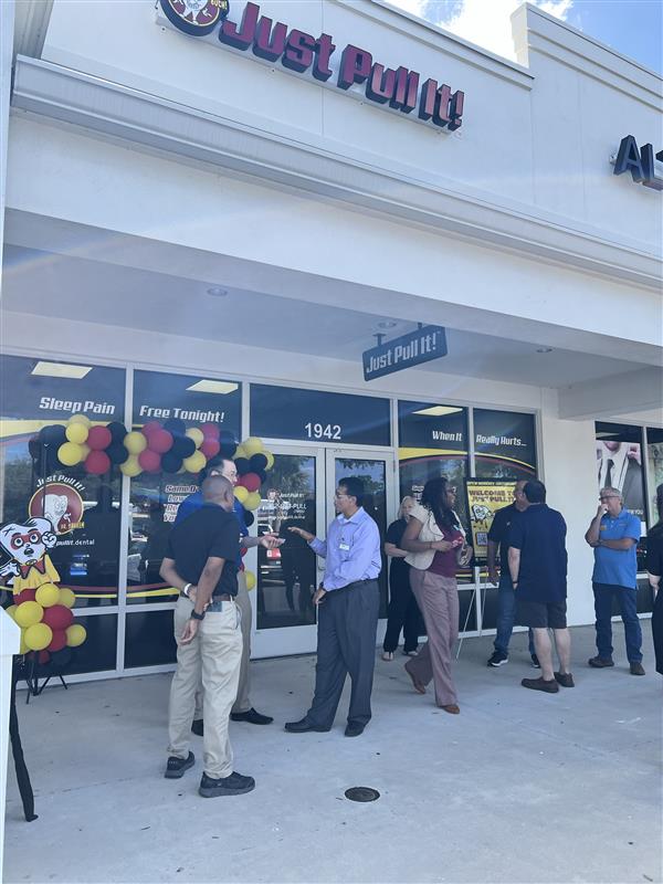 Guests gathered outside the Lutz storefront for the ribbon cutting