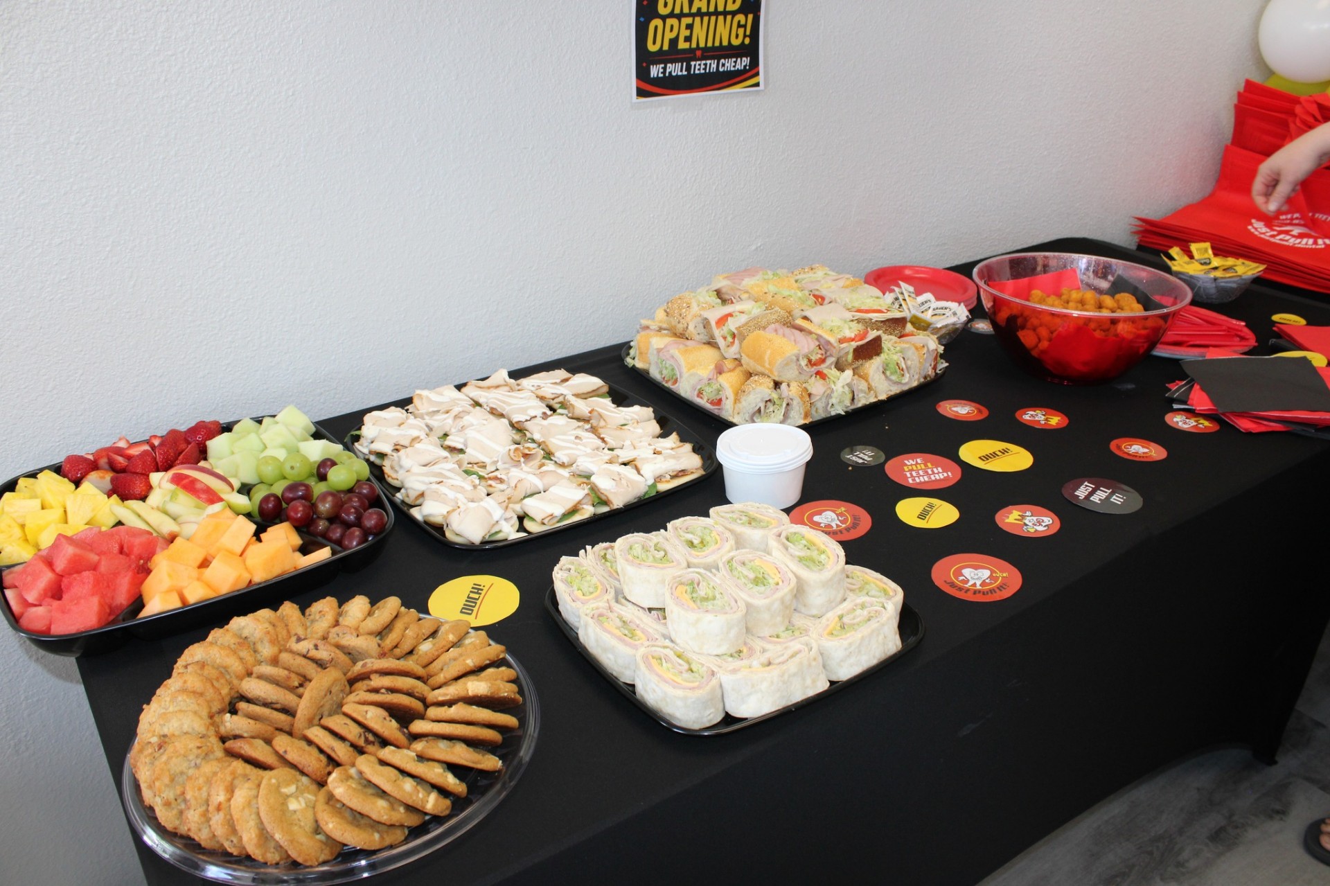 Grand opening spread of sandwiches, fruit, and cookies at the Pinellas Park office